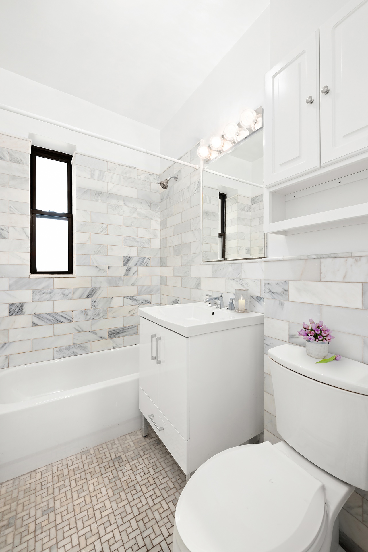 65 Morton Street, Unit 2N Manhattan, NY 10014 - Photo 7 of 12 a bathroom with a sink toilet vanity and bathtub