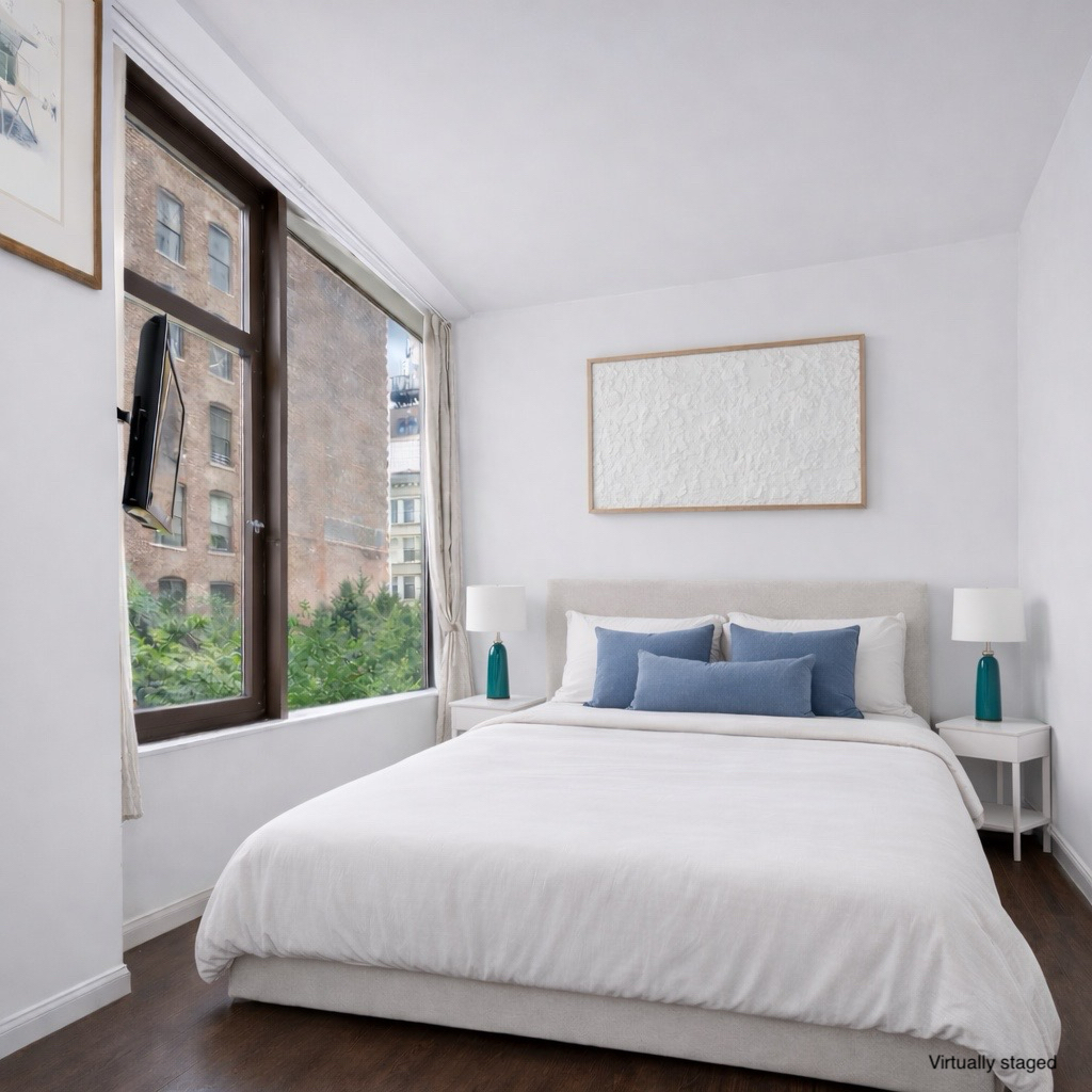 101 West 24th Street, Unit 4G Manhattan, NY 10011 - Photo 5 of 7 a bedroom with a large bed and a window