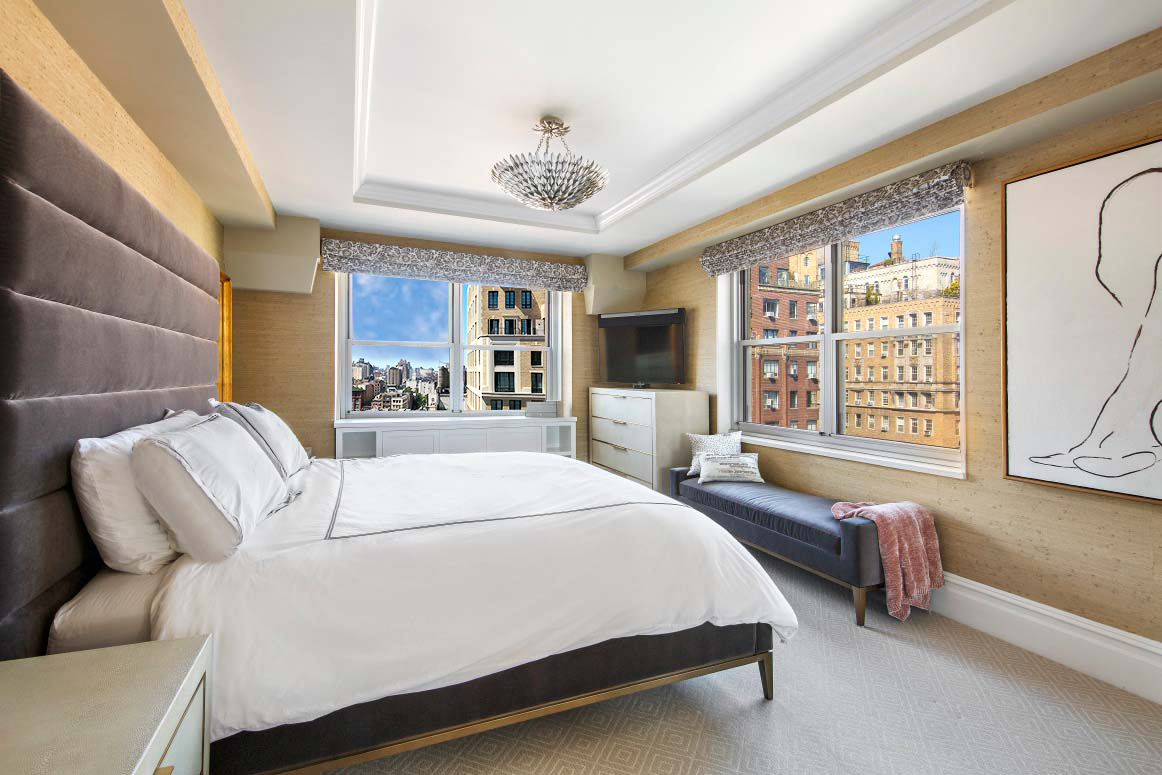 11 5th Avenue, Unit 15H Manhattan, NY 10003 - Photo 5 of 10 a spacious bedroom with a large bed and a chandelier