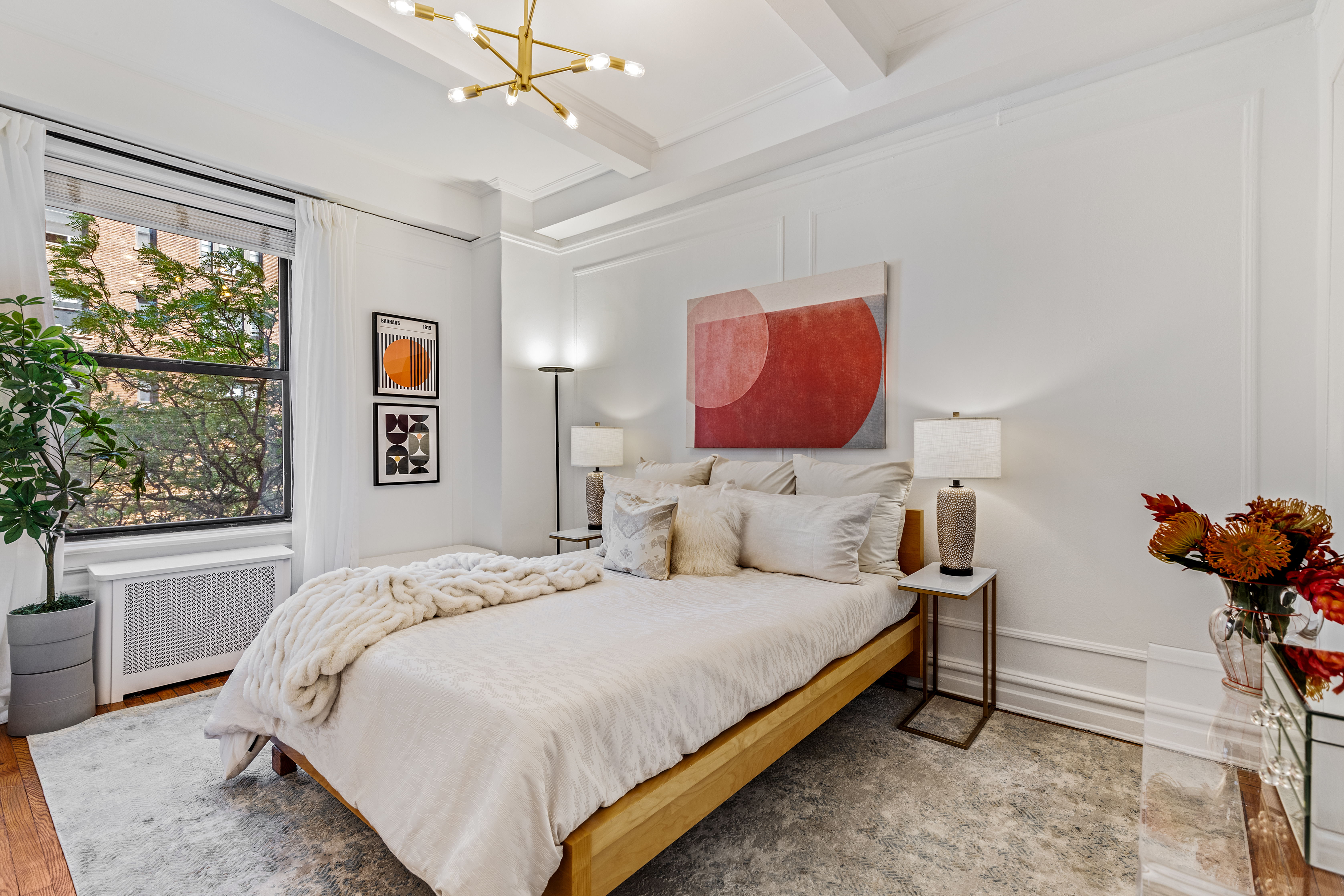 599 West End Avenue, Unit 5A Manhattan, NY 10024 - Photo 5 of 11 a bedroom with a bed and dresser with mirror