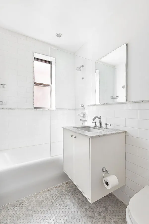 a bathroom with a sink a toilet and mirror
