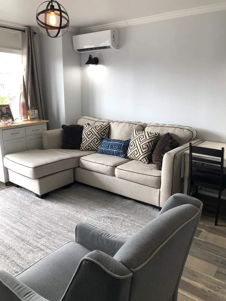 a living room with furniture and a flat screen tv