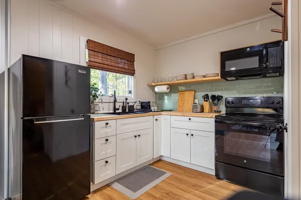 a kitchen with stainless steel appliances kitchen island granite countertop a refrigerator and a sink