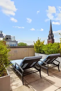 a view of a terrace with chairs and a table