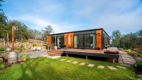 a view of a house with swimming pool and sitting area