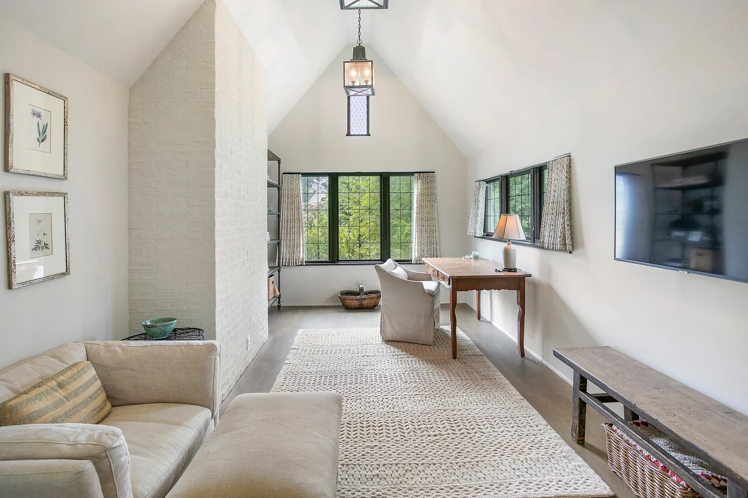 a living room with furniture a window and a table