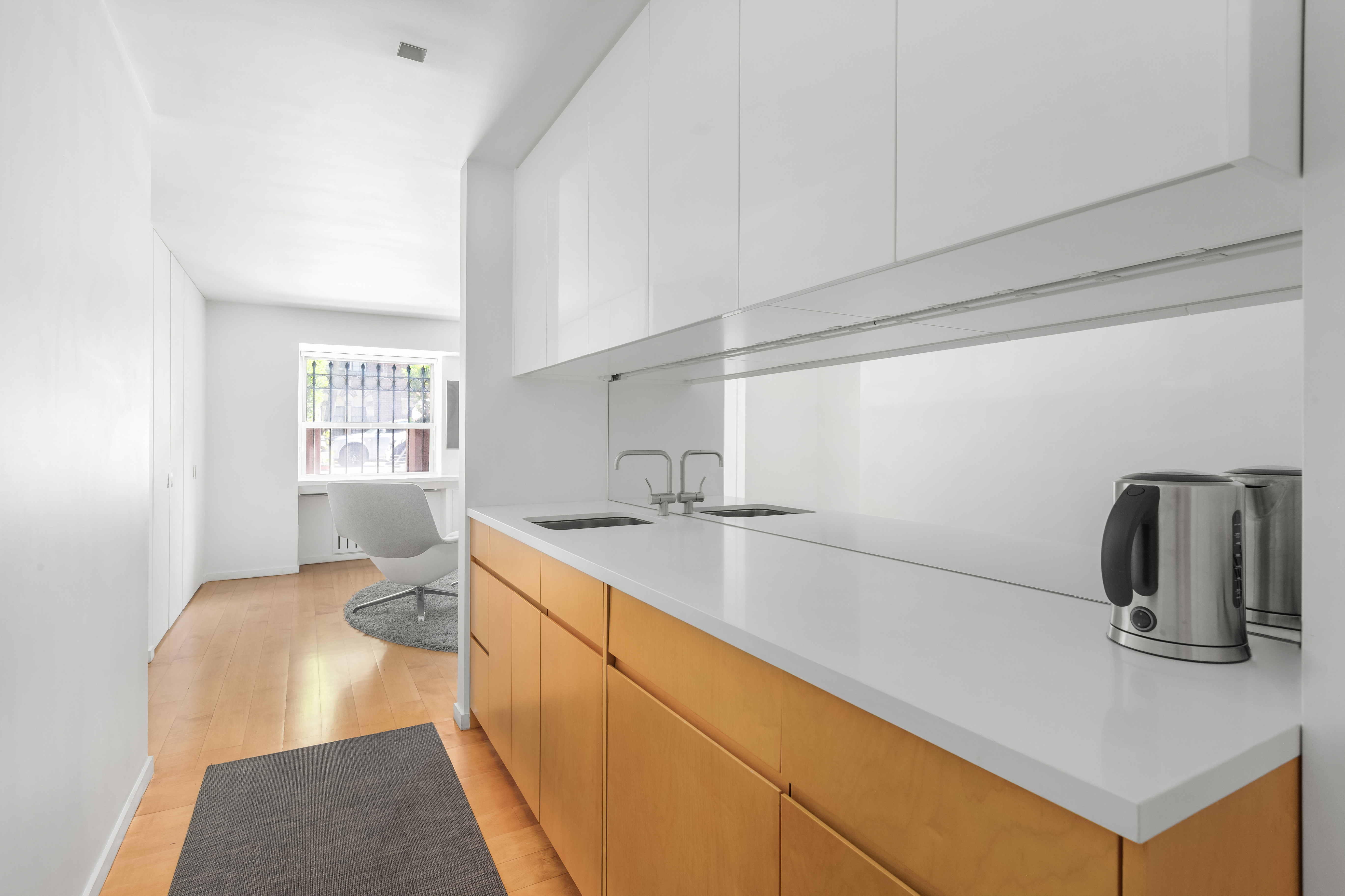 120 East 19th Street Manhattan, NY 10003 - Photo 19 of 33 a kitchen with a sink and a refrigerator