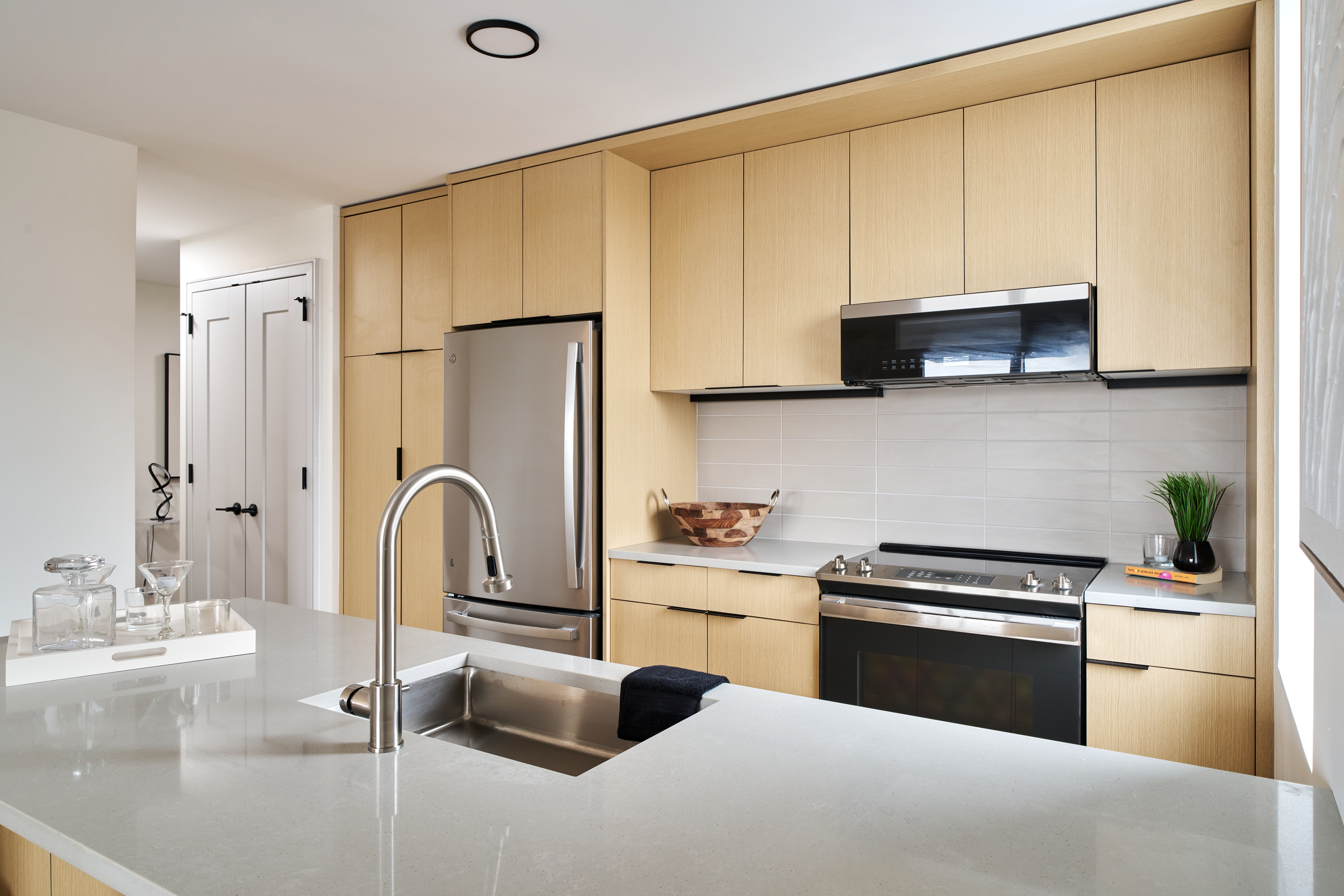 4414 Douglaston Parkway, Unit 6C Queens, NY 11363 - Photo 3 of 14 a kitchen with stainless steel appliances a stove sink and cabinets