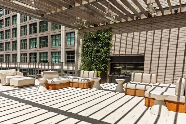 a outdoor space with patio the couches and a dining table with the view of swimming pool