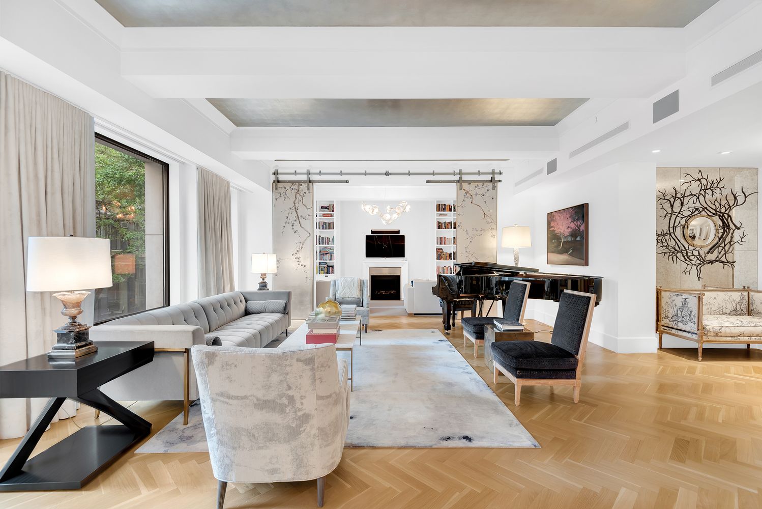 a living room with fireplace furniture and a large window