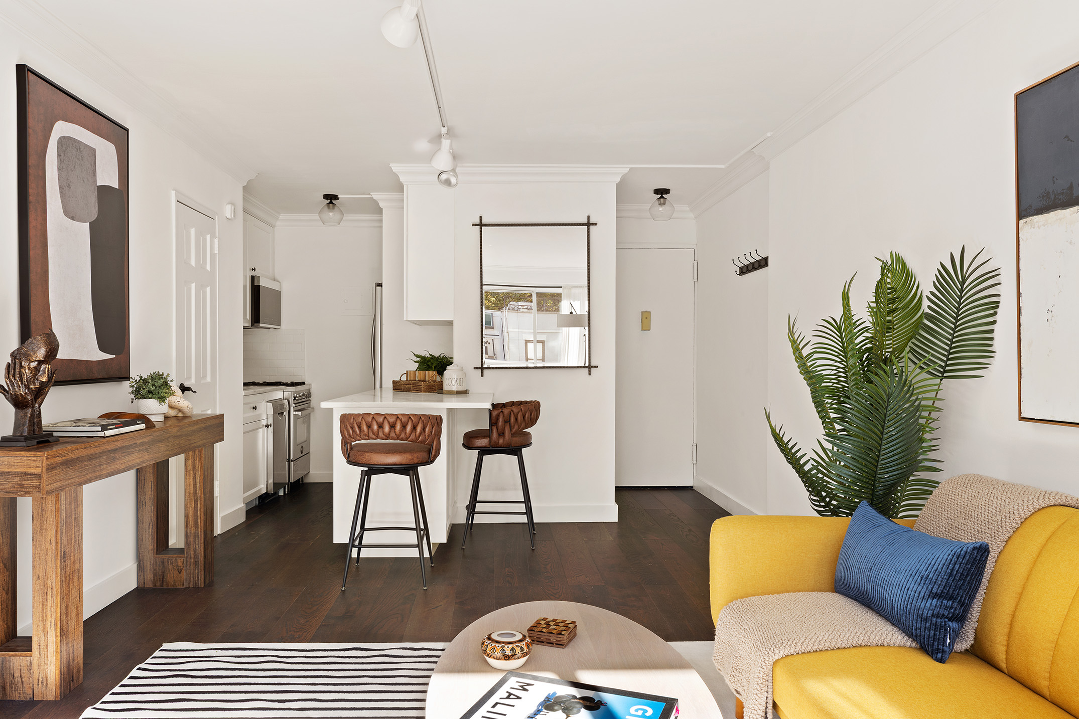 201 West 21st Street, Unit 5J Manhattan, NY 10011 - Photo 6 of 10 a living room with furniture a window and a wooden floor