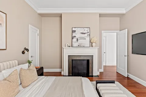 a bedroom with a bed and a fireplace