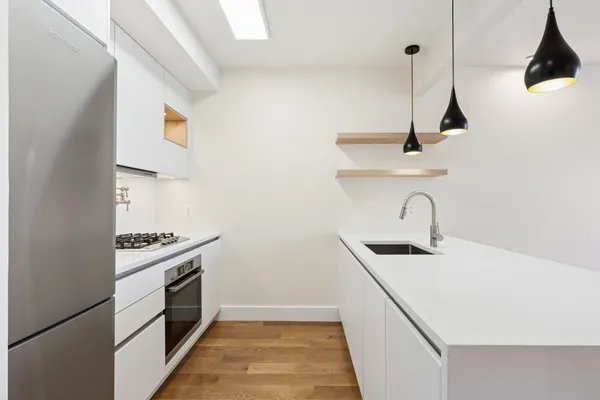 a kitchen with a sink a stove and a refrigerator