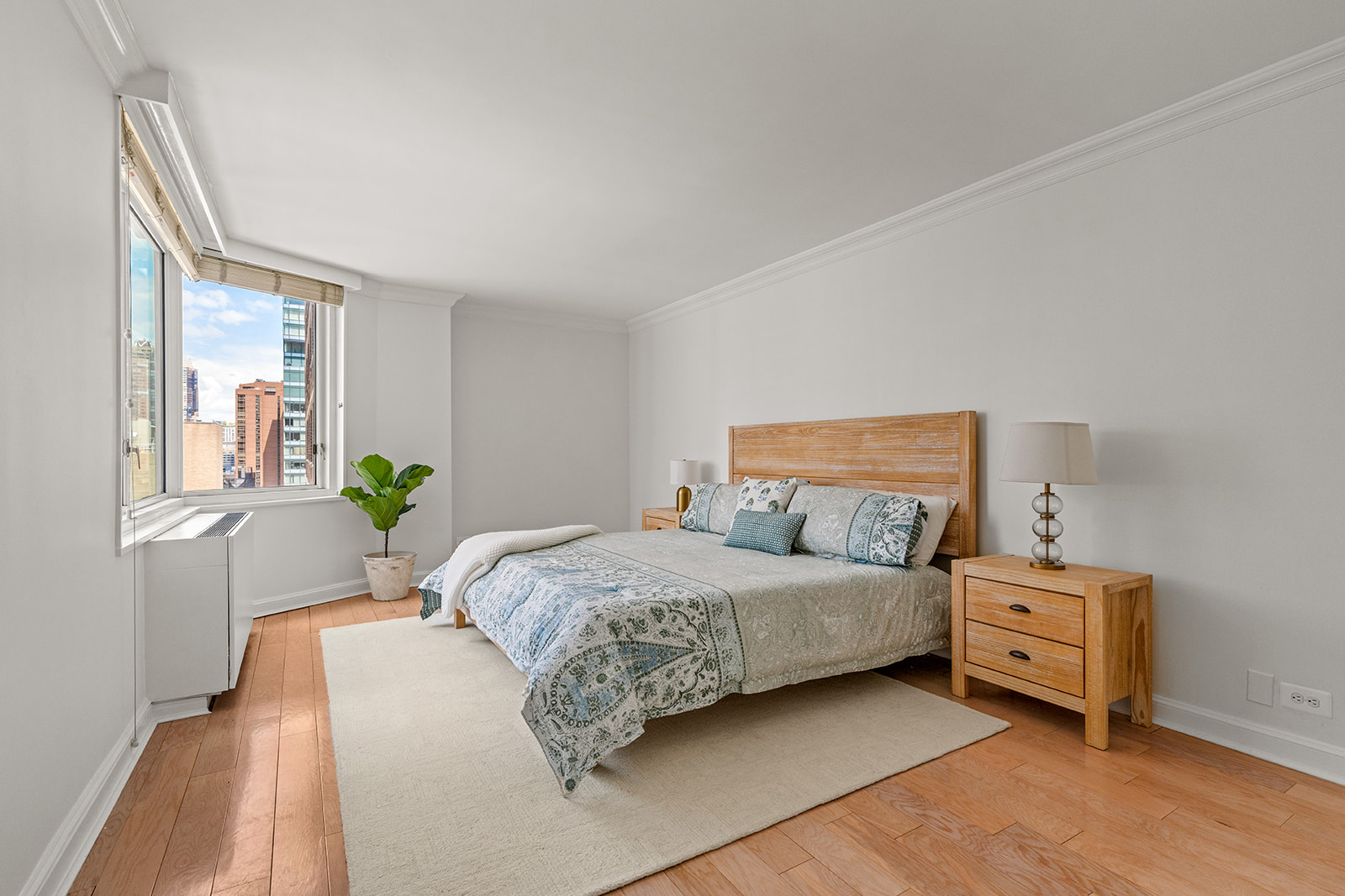 245 East 54th Street, Unit 25ST Manhattan, NY 10022 - Photo 4 of 8 a bedroom with a bed dresser and a window