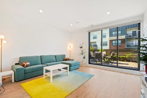 a living room with furniture and a rug