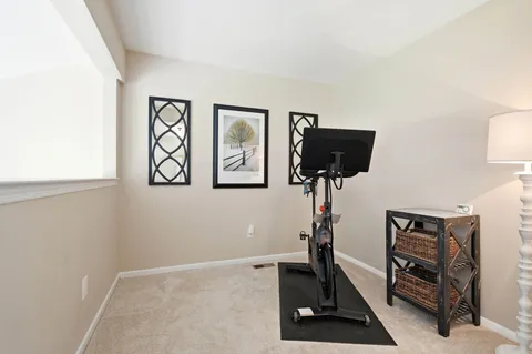 a room with gym equipment and a window