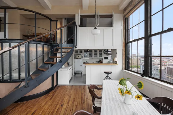 a kitchen with furniture a stove and a wooden floor