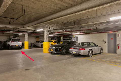 a view of parking garage with cars parked