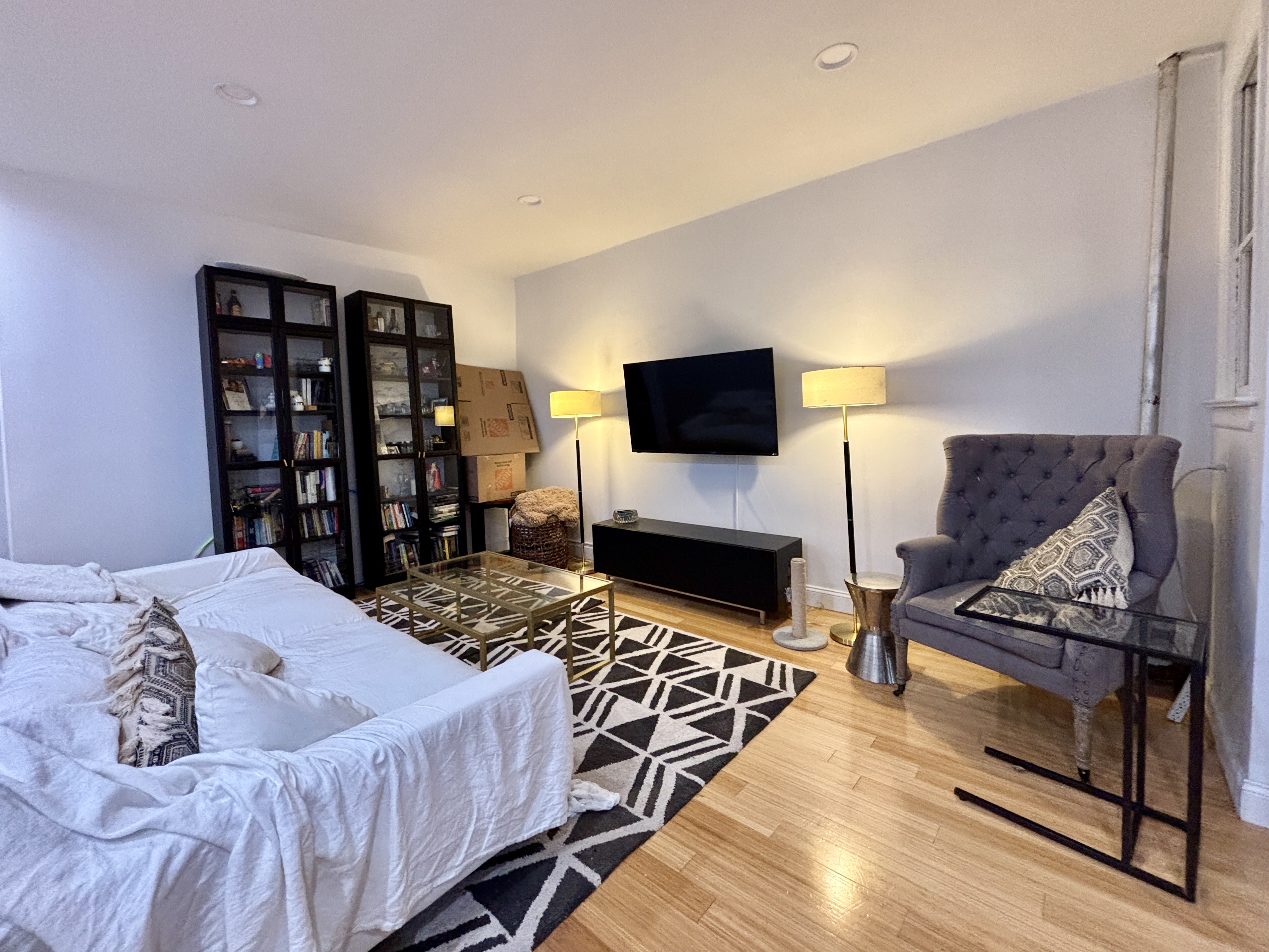 848 Macon Street, Unit PARLOR Brooklyn, NY 11233 - Photo 2 of 10 a bedroom with a bed and a flat screen tv