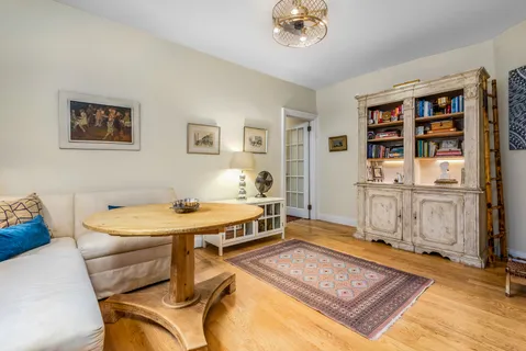 a living room with a couch and bookshelf