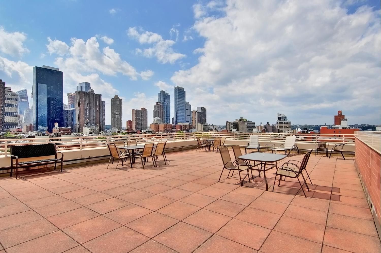 393 West 49th Street, Unit 6G Manhattan, NY 10019 - Photo 10 of 12 a view of a patio with dining table and chairs
