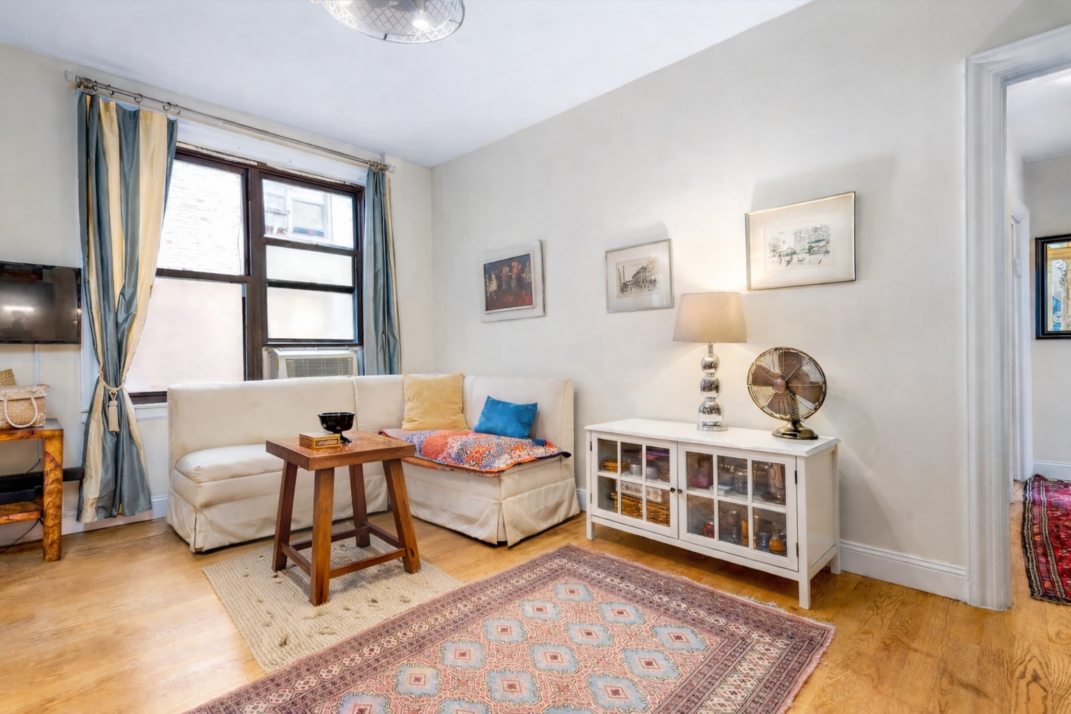 345 East 77th Street, Unit 3C Manhattan, NY 10075 - Photo 2 of 9 a reading room with furniture and a window