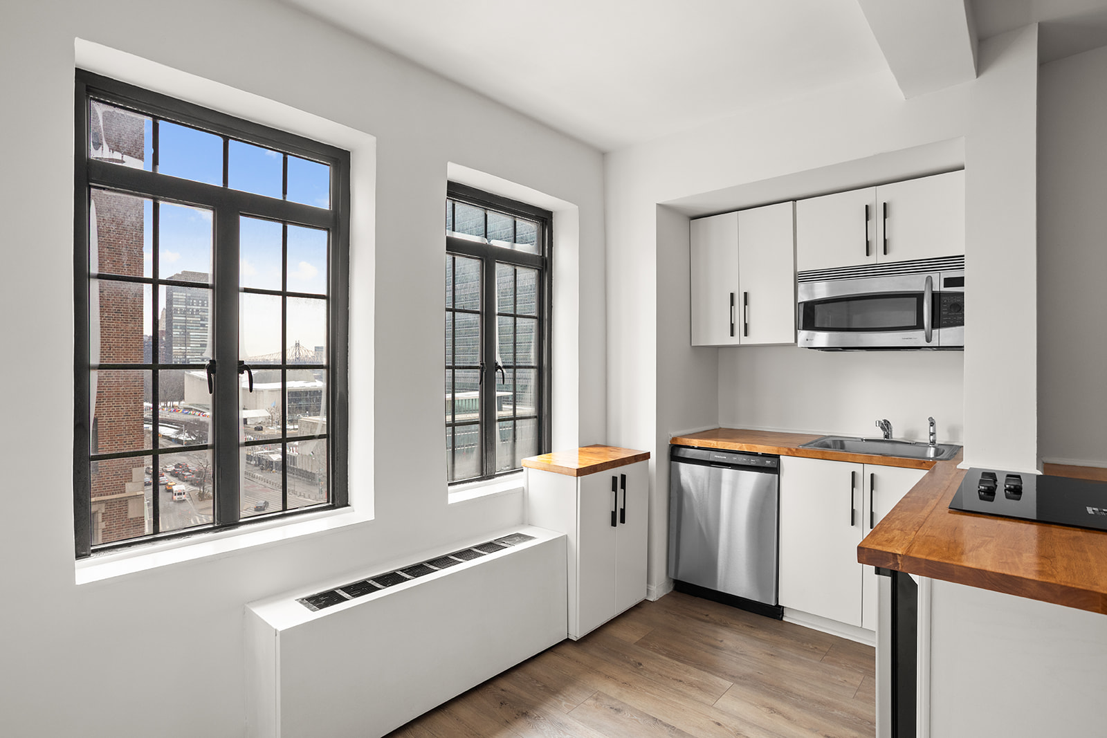 5 Tudor City Place, Unit 602 Manhattan, NY 10017 - Photo 6 of 20 a kitchen with stainless steel appliances granite countertop a stove and a sink