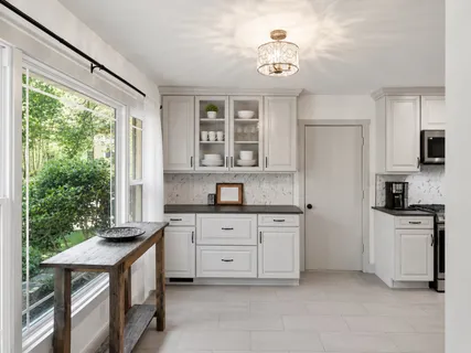 a kitchen with granite countertop a stove a sink dishwasher and a refrigerator with wooden floor