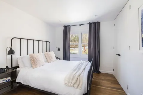 a bedroom with a bed and a window