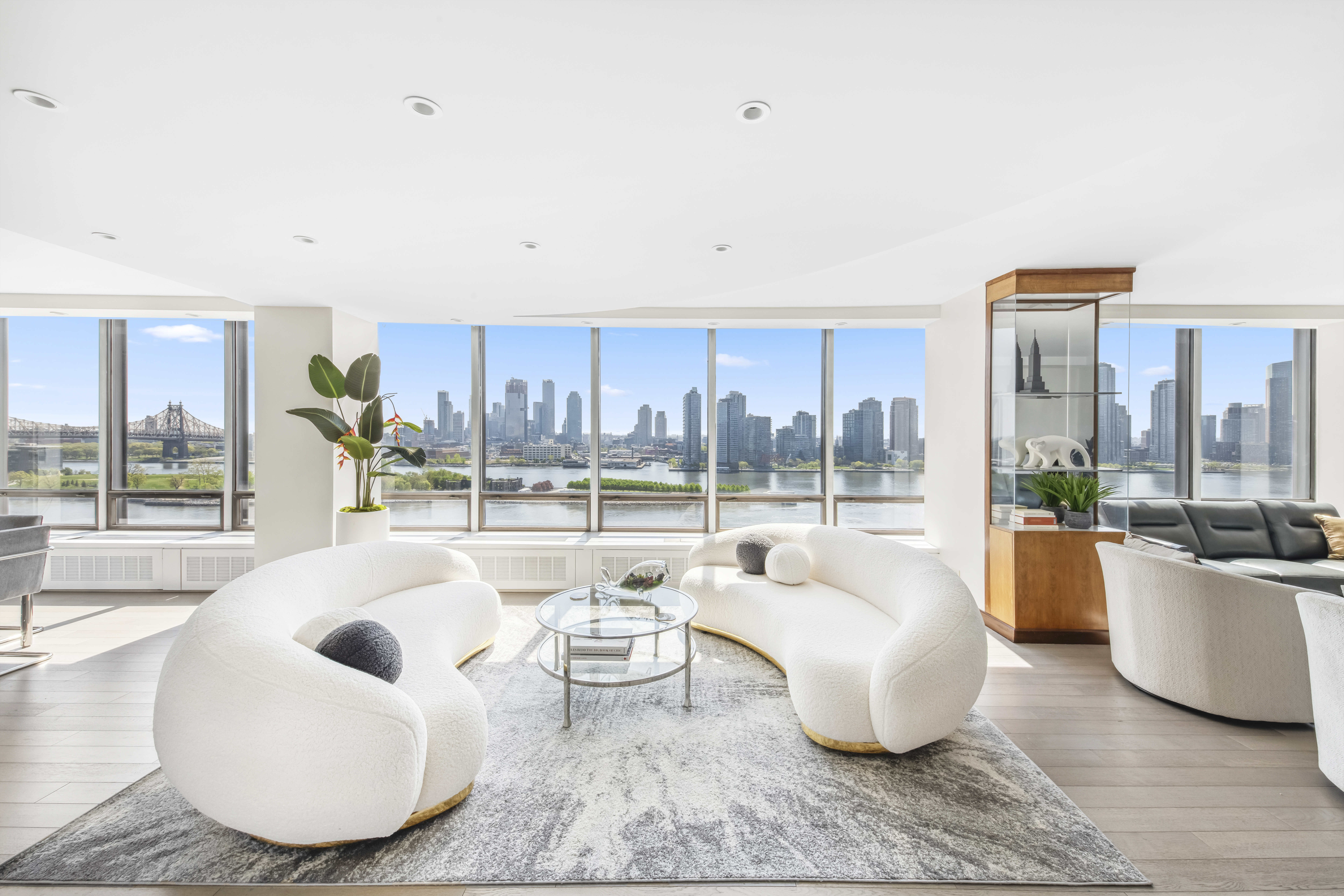870 United Nations Plaza, Unit 15E Manhattan, NY 10017 - Photo 2 of 19 a living room with furniture and a large window