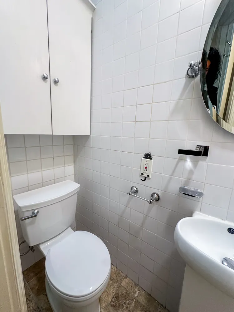 a white toilet sitting next to a bathroom sink