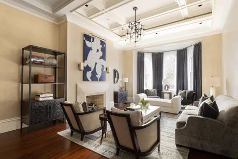 a living room with furniture and a chandelier