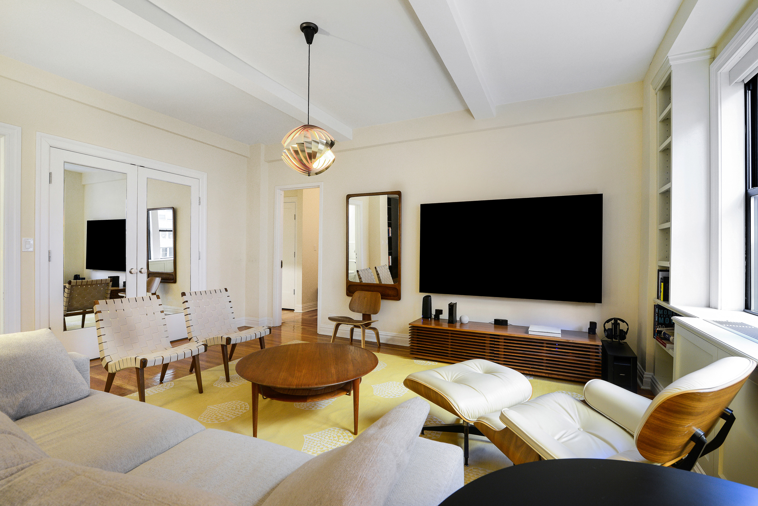 20 West 72nd Street, Unit 601 Manhattan, NY 10023 - Photo 3 of 21 a living room with furniture and a flat screen tv
