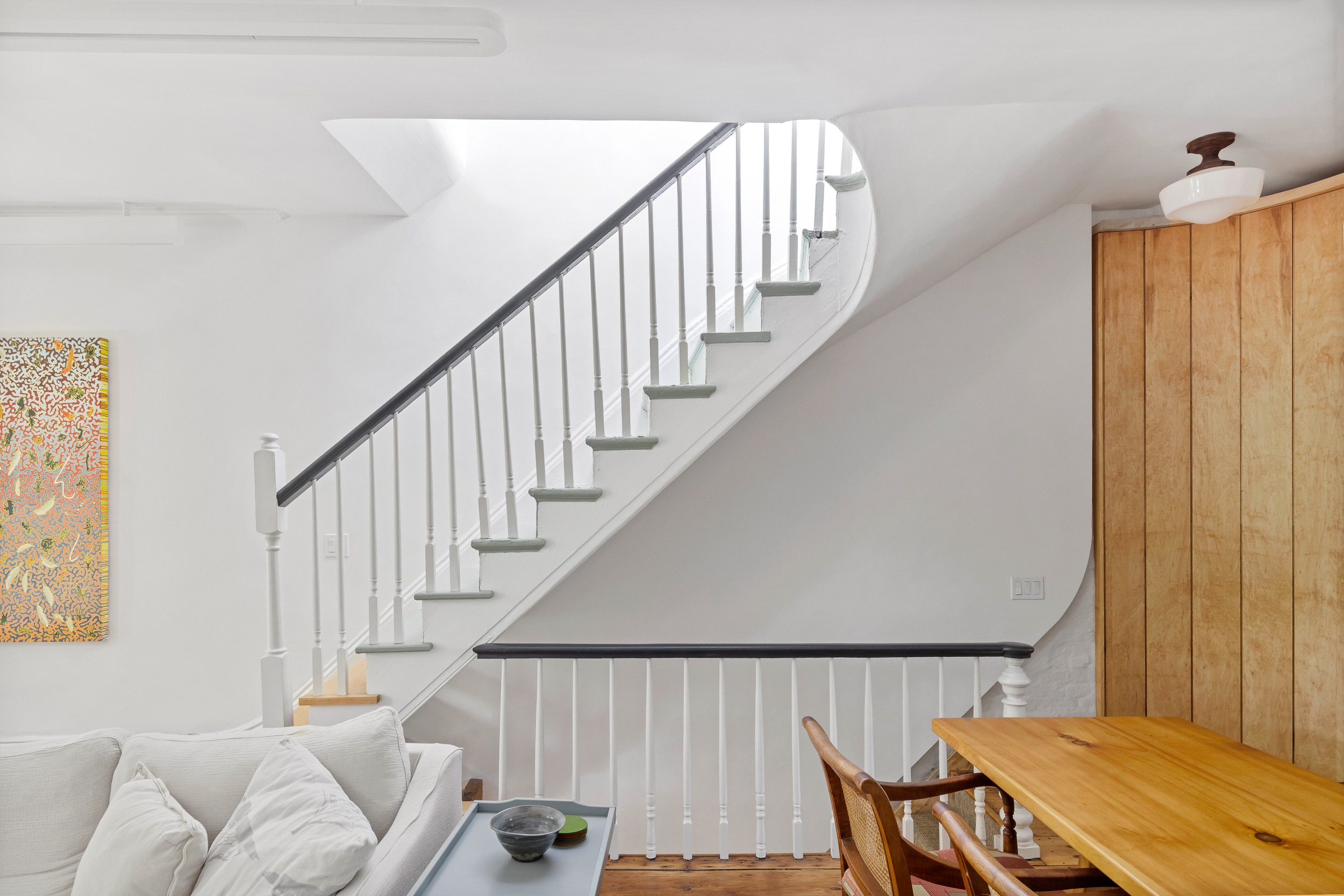 437 Warren Street Brooklyn, NY 11217 - Photo 7 of 17 a view of a hallway with furniture and stairs