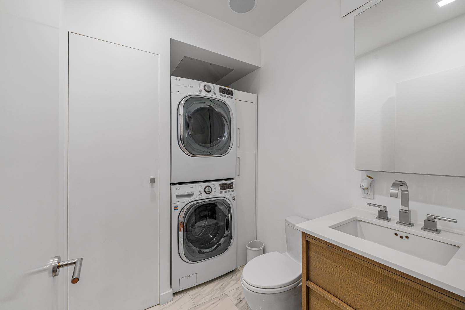 124 East 13th Street, Unit 3 Manhattan, NY 10003 - Photo 18 of 26 a utility room with sink dryer and washer
