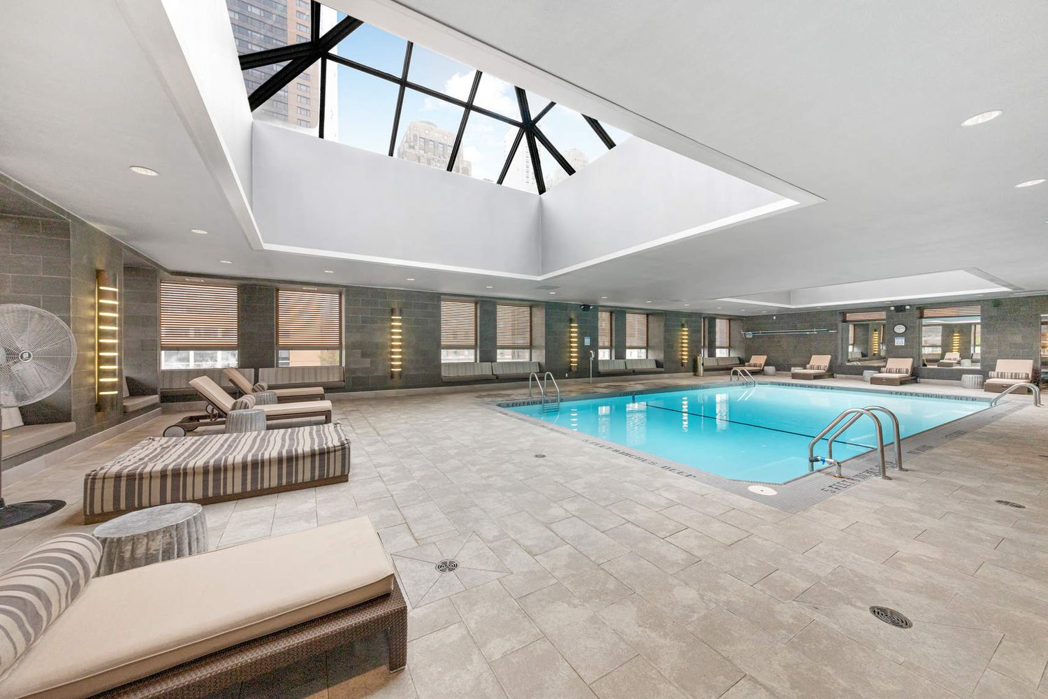 225 Rector Place, Unit 7M Manhattan, NY 10280 - Photo 7 of 13 a view of a livingroom with furniture and staircase