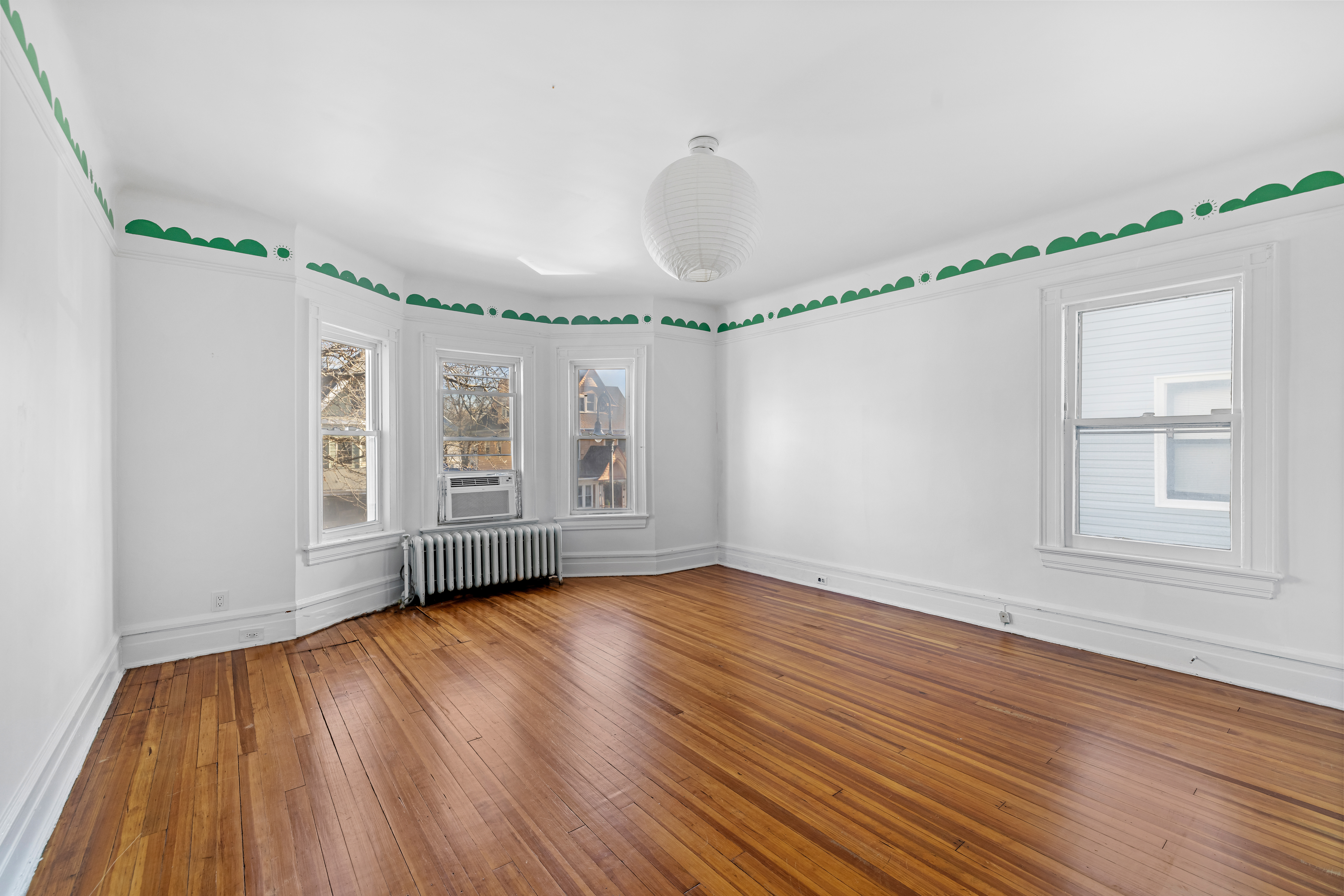 792 East 21st Street Brooklyn, NY 11210 - Photo 18 of 29 a view of an empty room with wooden floor and a window