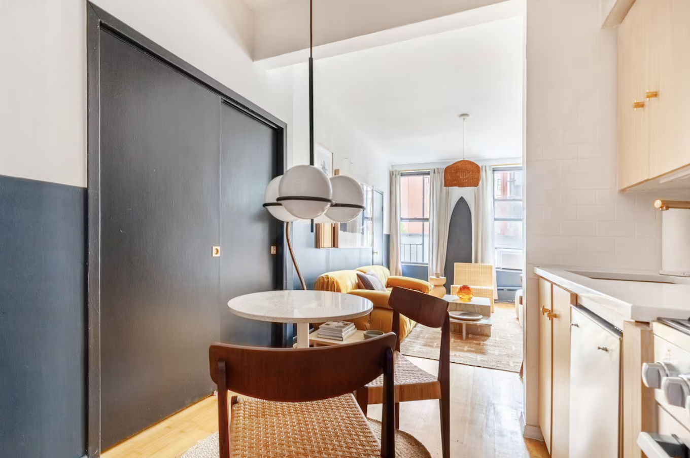 240 Mulberry Street, Unit 2 Manhattan, NY 10012 - Photo 11 of 19 a kitchen with a table and chairs in it