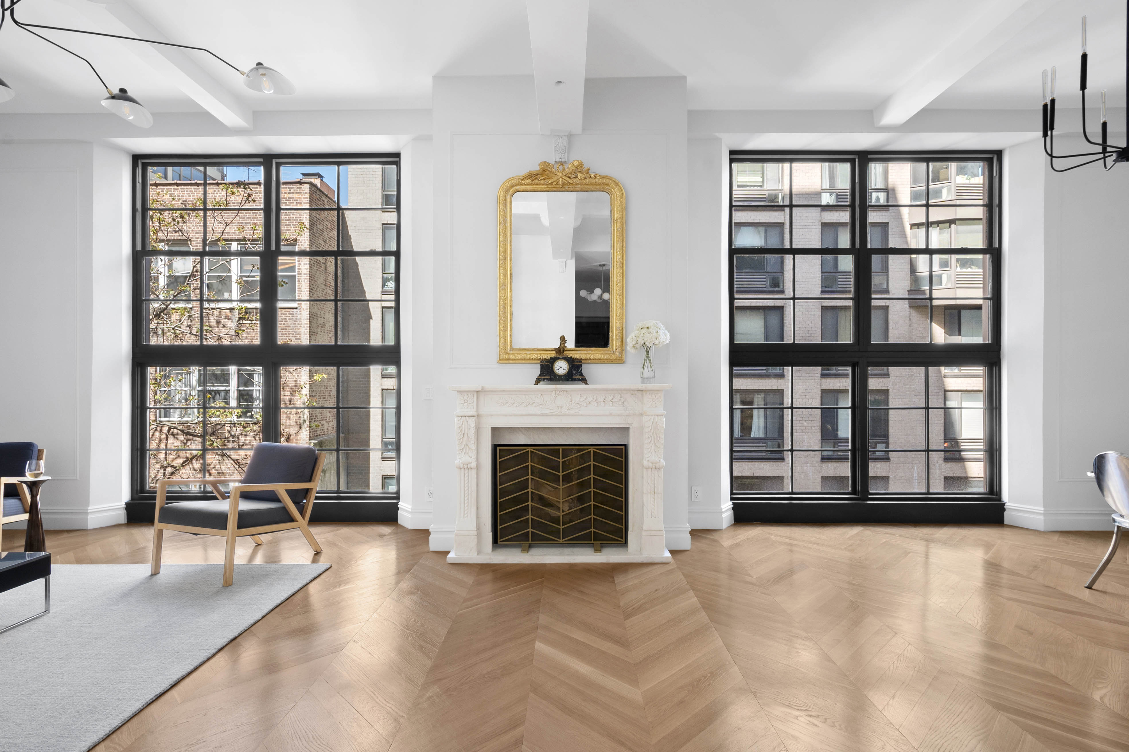 33 West 67th Street, Unit 4M Manhattan, NY 10023 - Photo 2 of 16 wooden floor fireplace and windows in an empty room