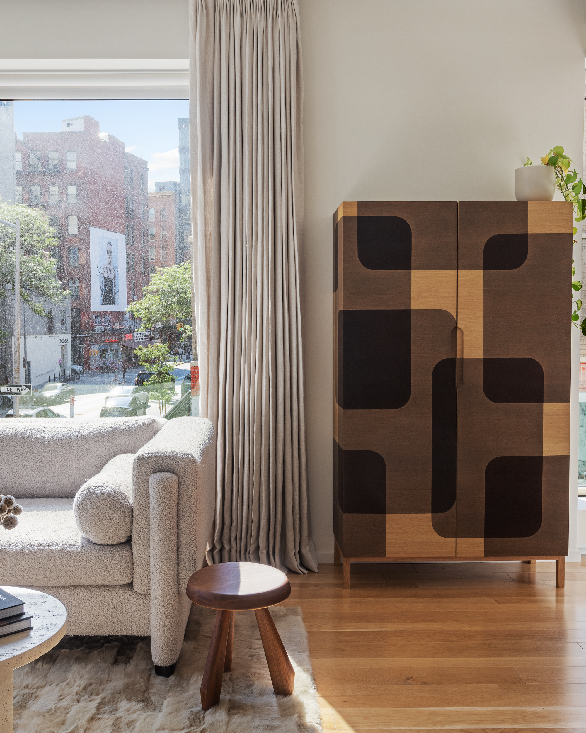 75 Kenmare Street, Unit 2D Manhattan, NY 10012 - Photo 7 of 15 a living room with furniture and a large window