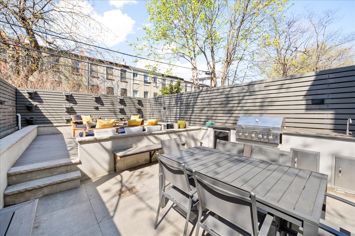 577 Madison Street, Unit 1B Brooklyn, NY 11221 - Photo 5 of 15 a view of a roof deck with couches and potted plants