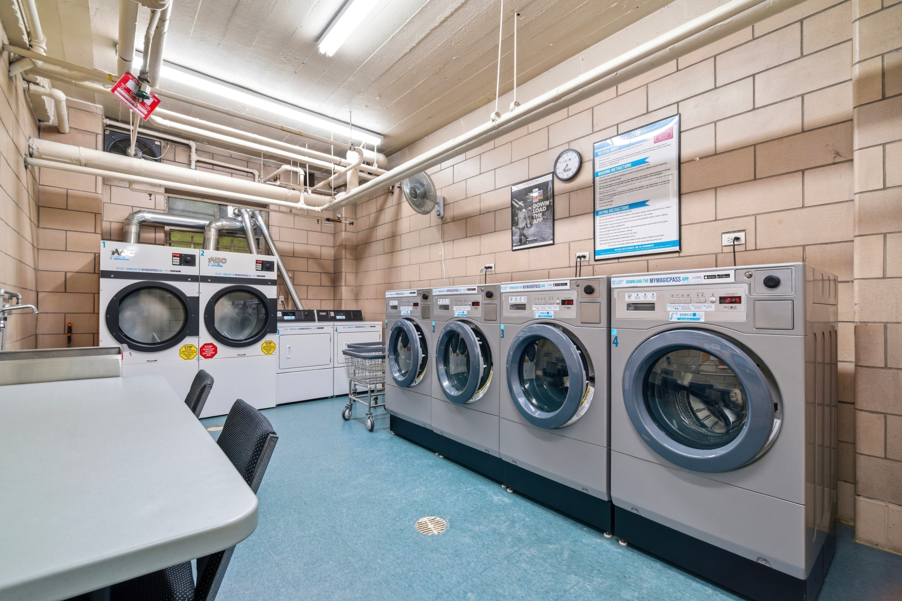 240 East 46th Street, Unit 8J Manhattan, NY 10017 - Photo 10 of 11 a utility room with dryer and washer