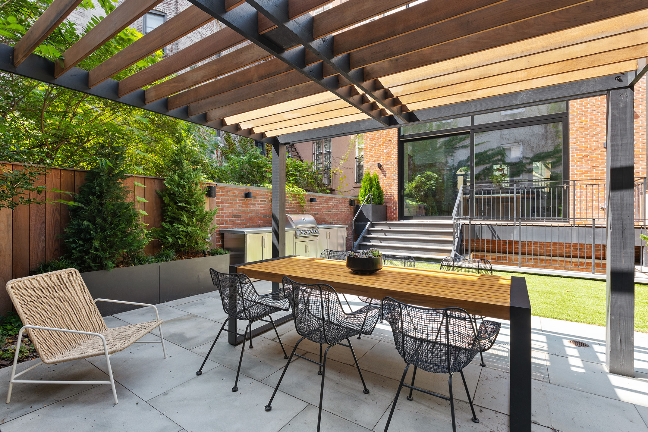205 Clinton Street Brooklyn, NY 11201 - Photo 19 of 39 a roof deck with table and chairs and potted plants