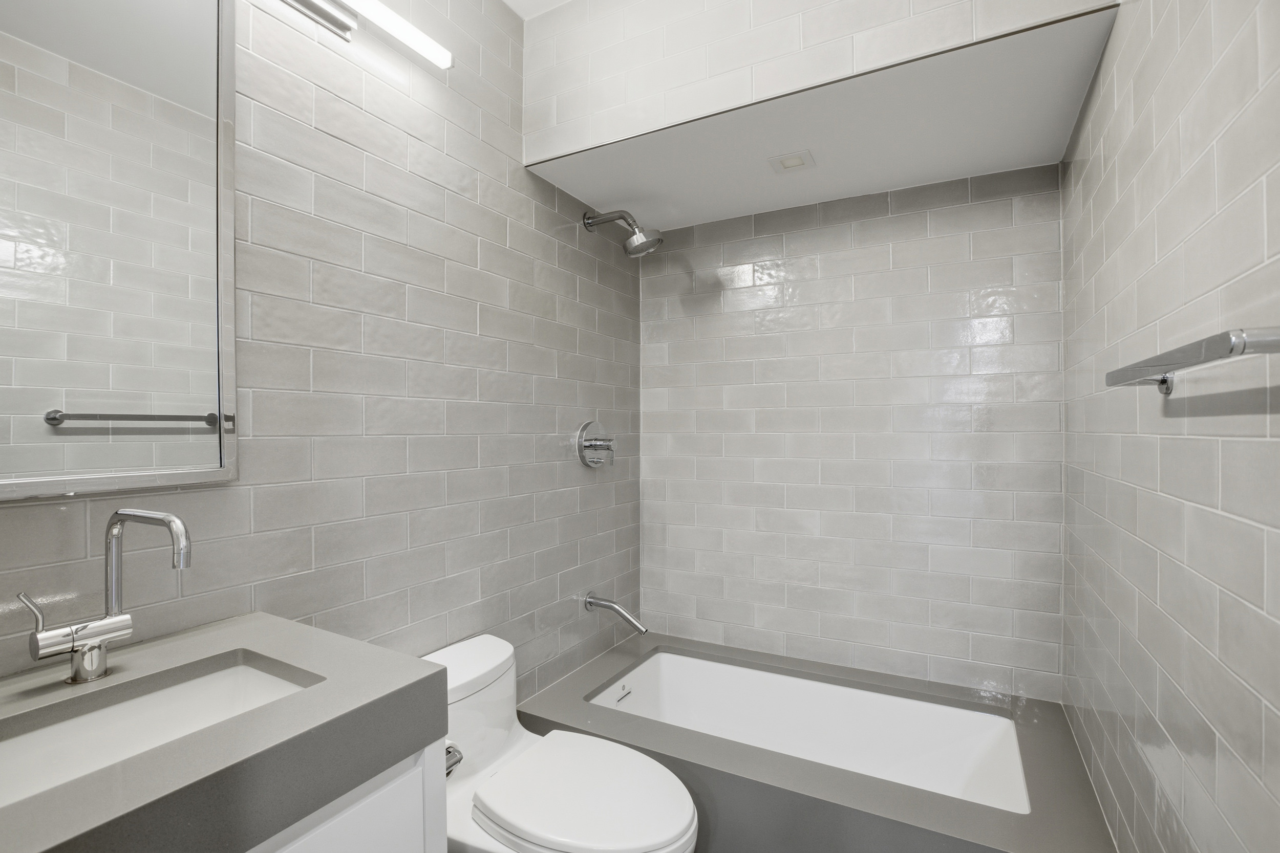 309 East 49th Street, Unit 21A Manhattan, NY 10017 - Photo 13 of 18 a bathroom with a toilet a sink and shower