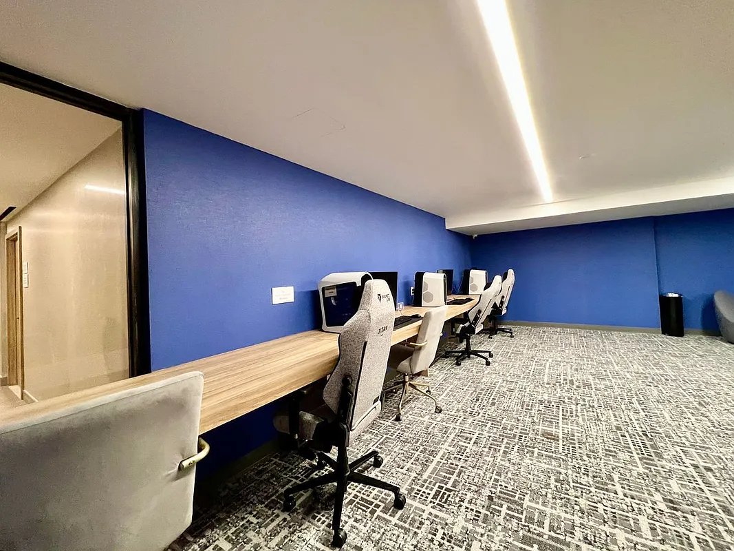 46-30 Center Boulevard, Unit 710 Queens, NY 11109 - Photo 22 of 25 a bed room with a bed and a desk