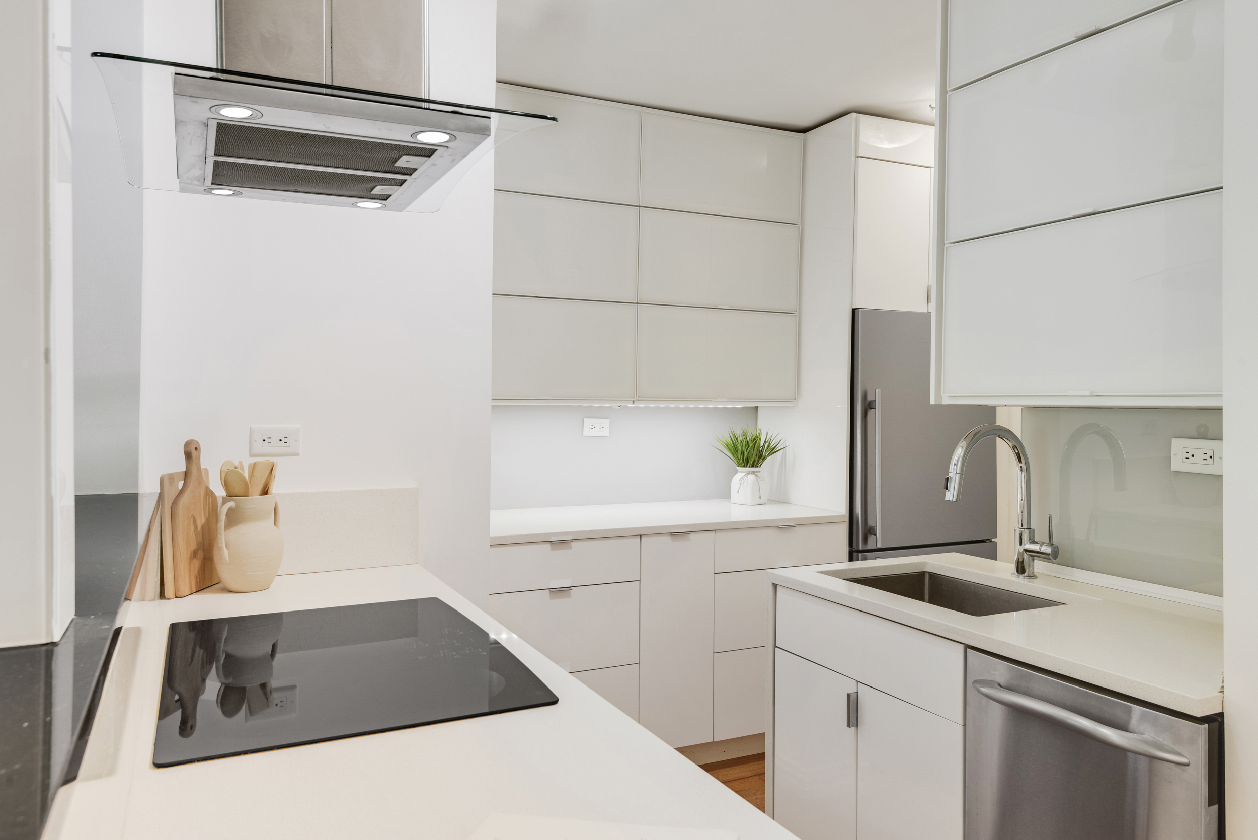 330 East 70th Street, Unit 4F Manhattan, NY 10021 - Photo 6 of 14 a kitchen with a sink and a refrigerator
