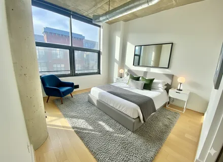 a bedroom with a bed and glass window