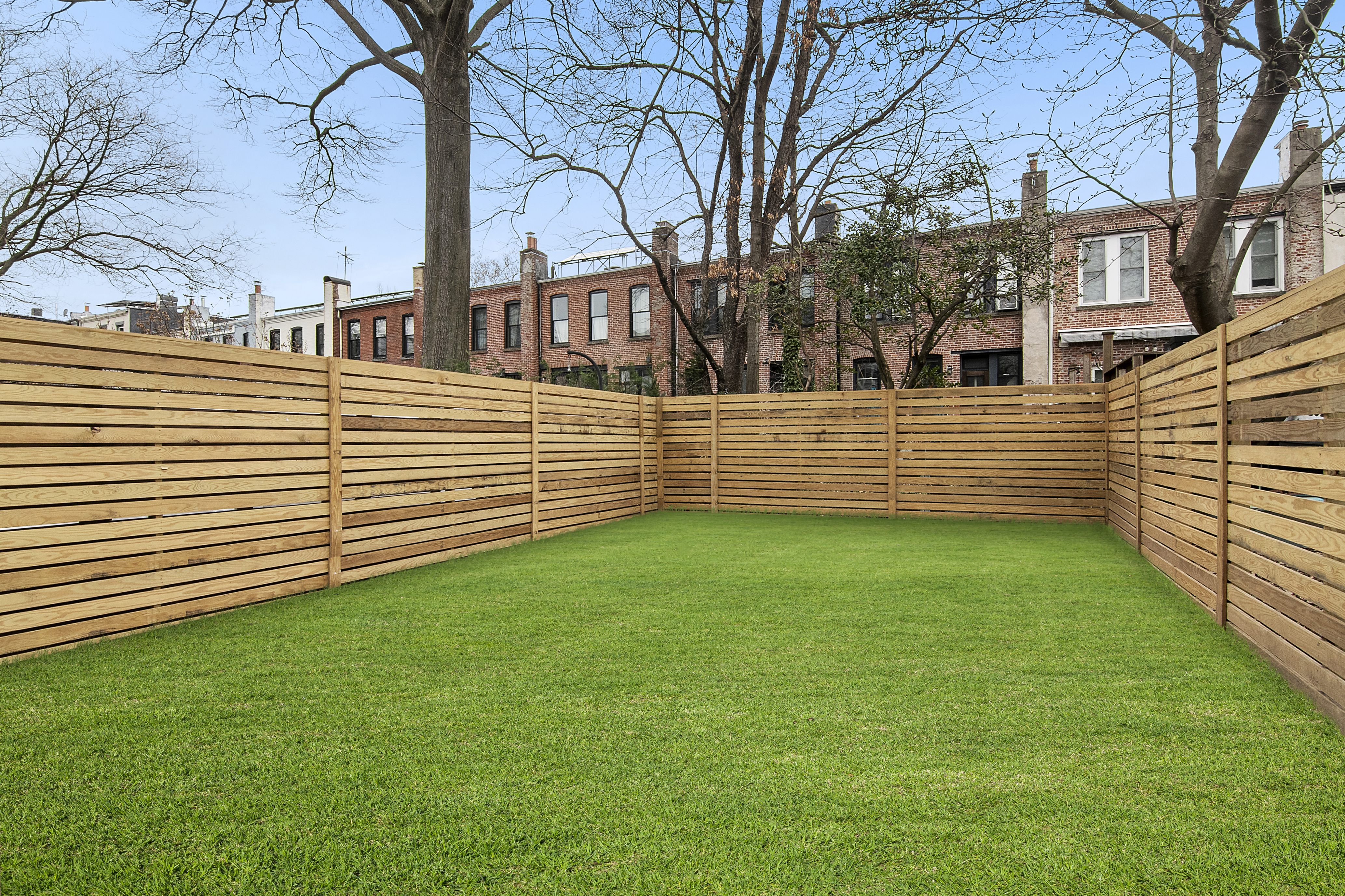 195 Rutland Road Brooklyn, NY 11225 - Photo 19 of 21 a view of a back yard with a wooden fence
