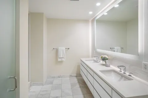 a bathroom with a glass shower door