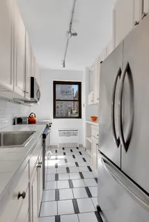 a kitchen with stainless steel appliances granite countertop a sink and a stove top oven
